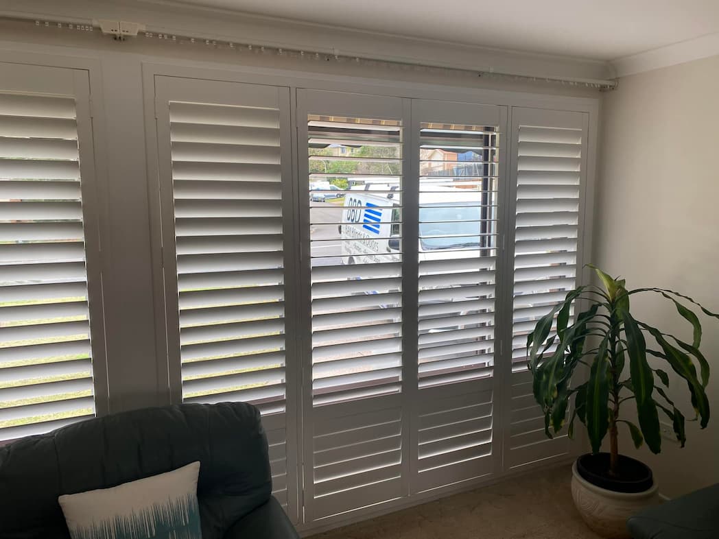 White Plantation Shutters in the Living Room — Blinds, Shutters & Awnings in Wyee, NSW