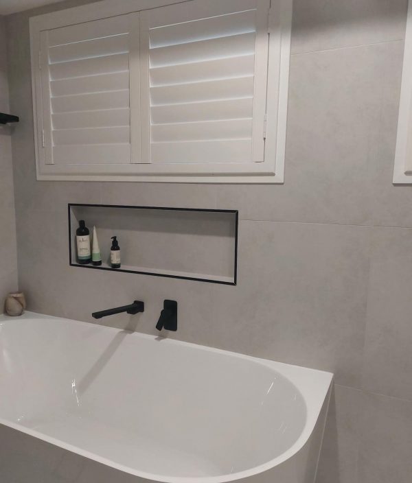 White Plantation Shutters in the Bathroom — Blinds, Shutters & Awnings in Wyee, NSW