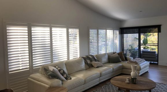 Plantation Shutters in the Living Room — Blinds, Shutters & Awnings in Erina, NSW